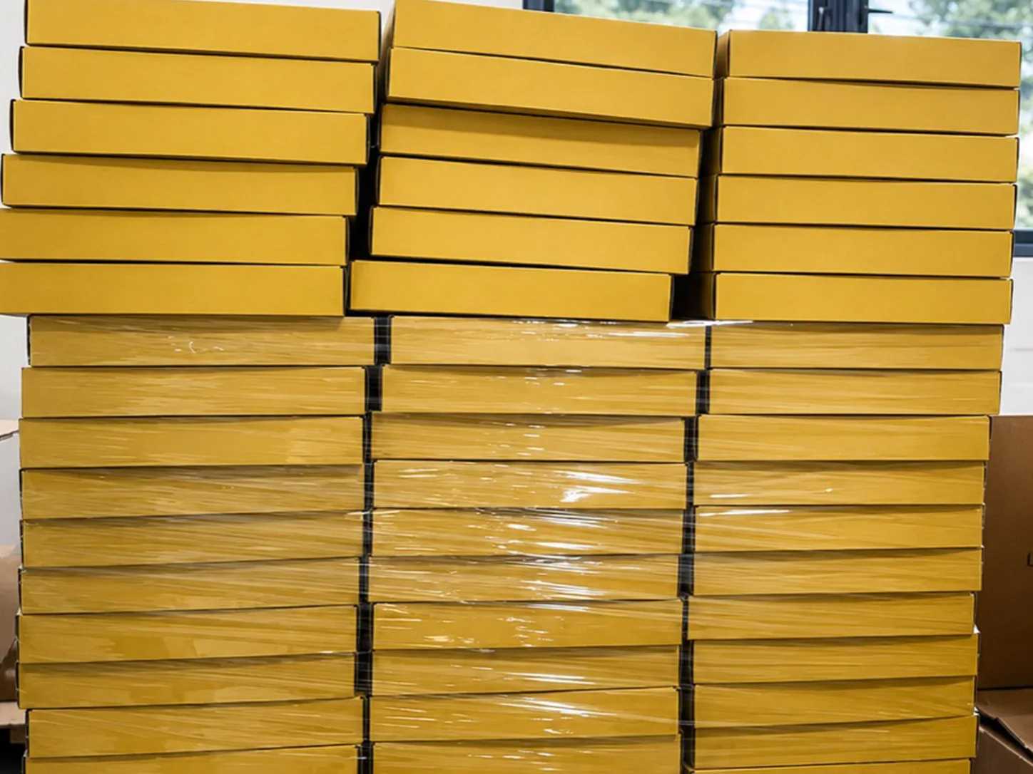Des piles de boîtes de produits emballées sous film, prêtes à être expédiées dans un entrepôt
